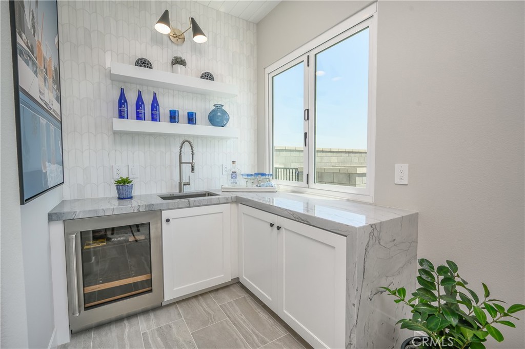 13093 Edgware Drive Rancho Cucamonga, CA 91739 - Photo 8 of 25 a kitchen with stainless steel appliances white cabinets and a window