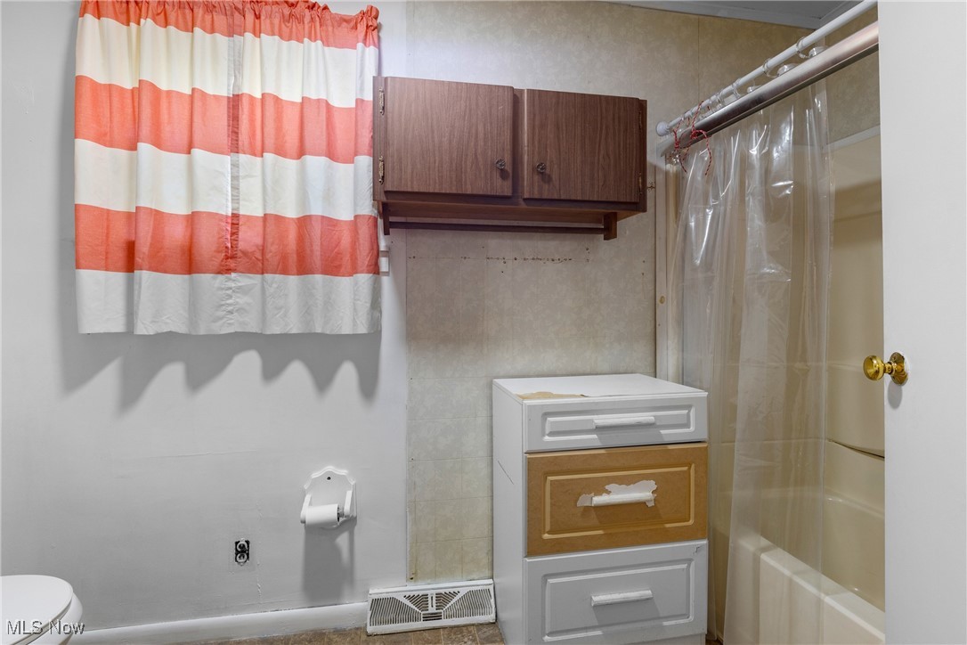102 Potrock Road Wellsburg, WV 26070 - Photo 14 of 42 Bathroom featuring shower / bath combo with shower curtain and toilet