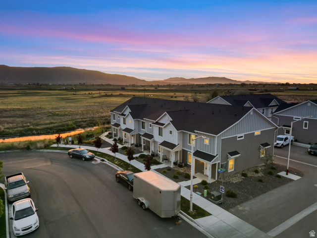 1223 East 1775 North Payson, UT 84651 - Photo 21 of 45 Modern townhome facade featuring light grey siding, white trim, and dark rooflines
