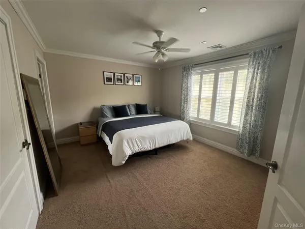 a spacious bedroom with a bed and a large window