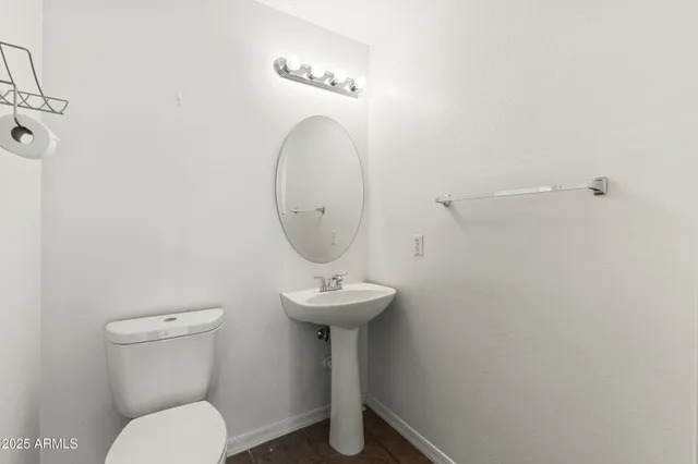 a bathroom with a sink mirror and toilet