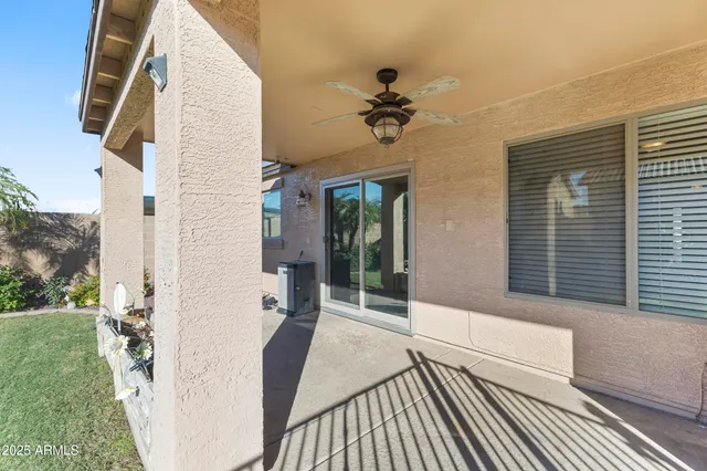 a view of a balcony with furniture and a yard