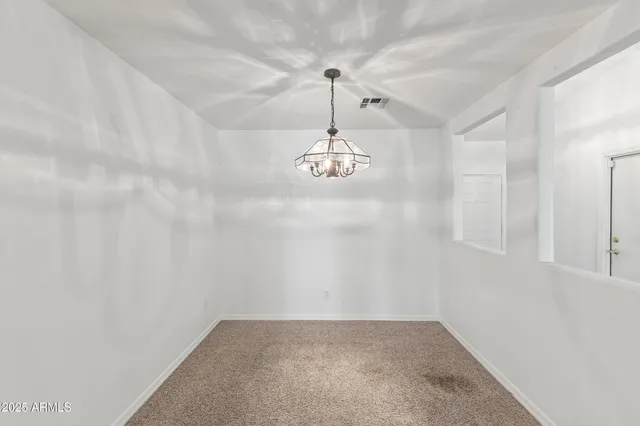 a view of a hallway with a chandelier fan