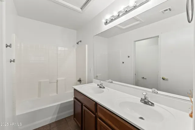 a bathroom with a bathtub a sink and a mirror