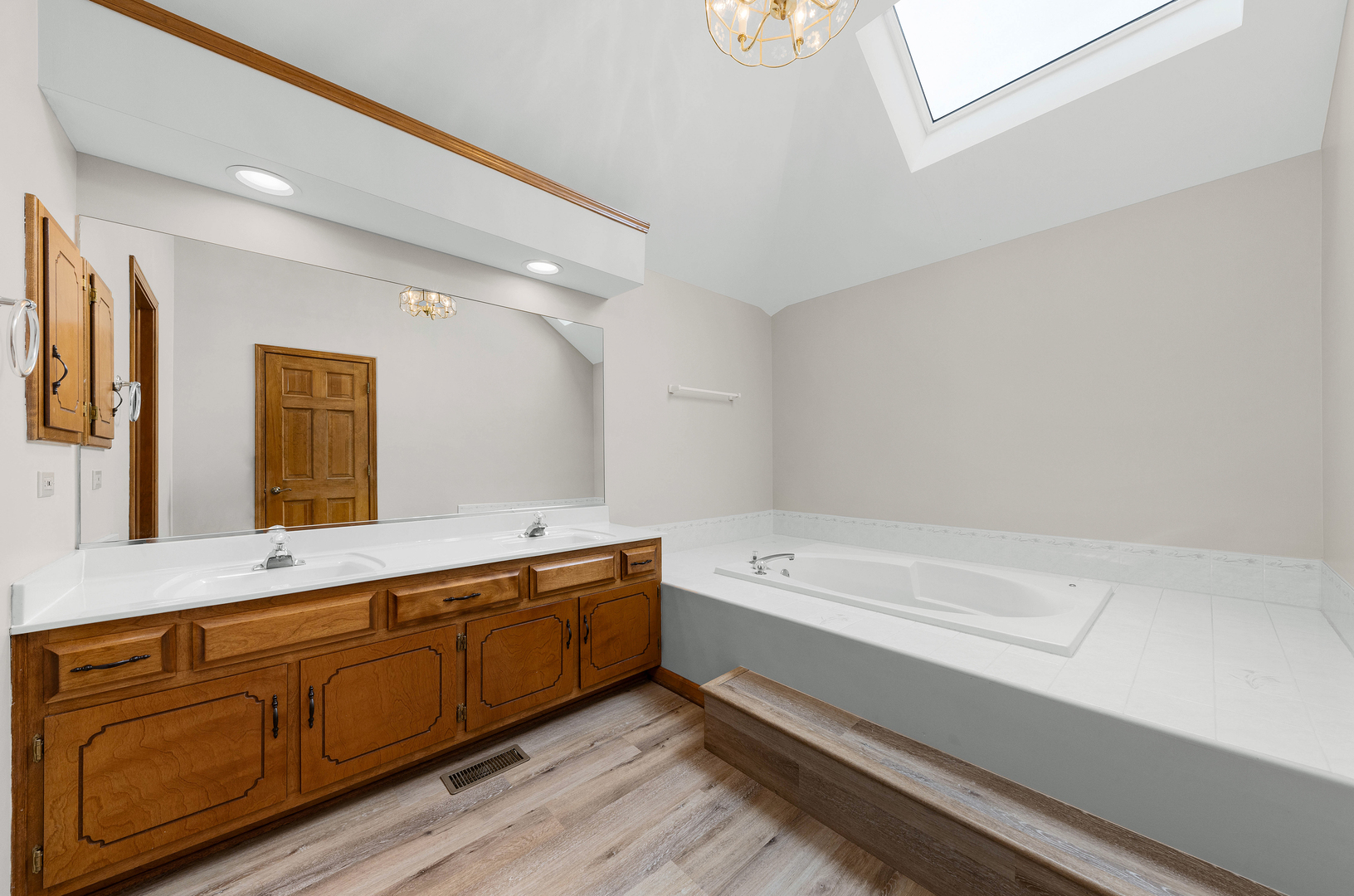 1751 Mundelein Road Naperville, IL 60565 - Photo 22 of 37 a bathroom with a tub a sink and mirror