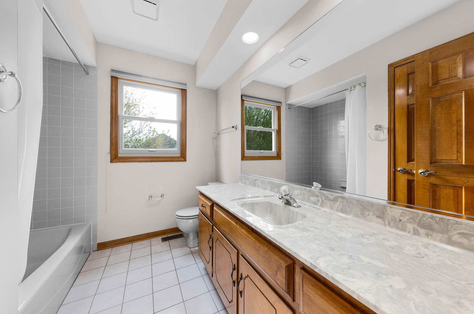 1751 Mundelein Road Naperville, IL 60565 - Photo 28 of 37 a bathroom with a granite countertop sink a mirror and a bathtub