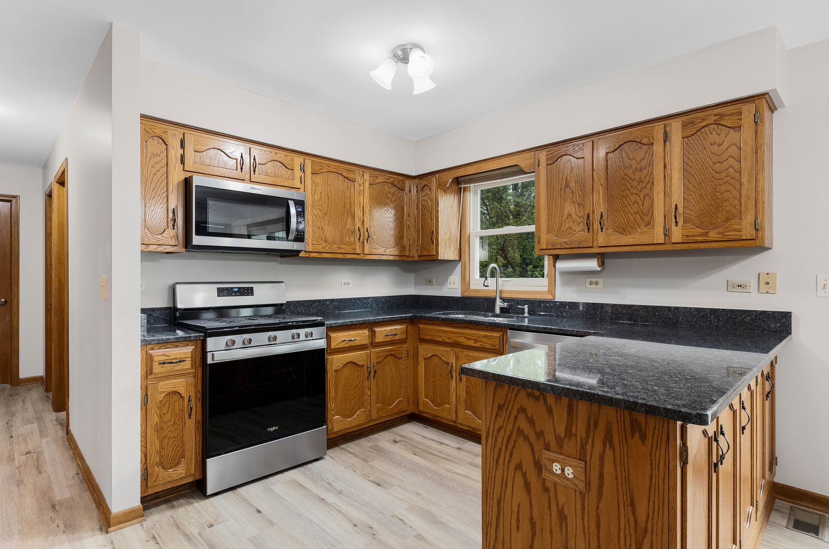 1751 Mundelein Road Naperville, IL 60565 - Photo 10 of 37 a kitchen with stainless steel appliances granite countertop wooden cabinets stove top oven and sink