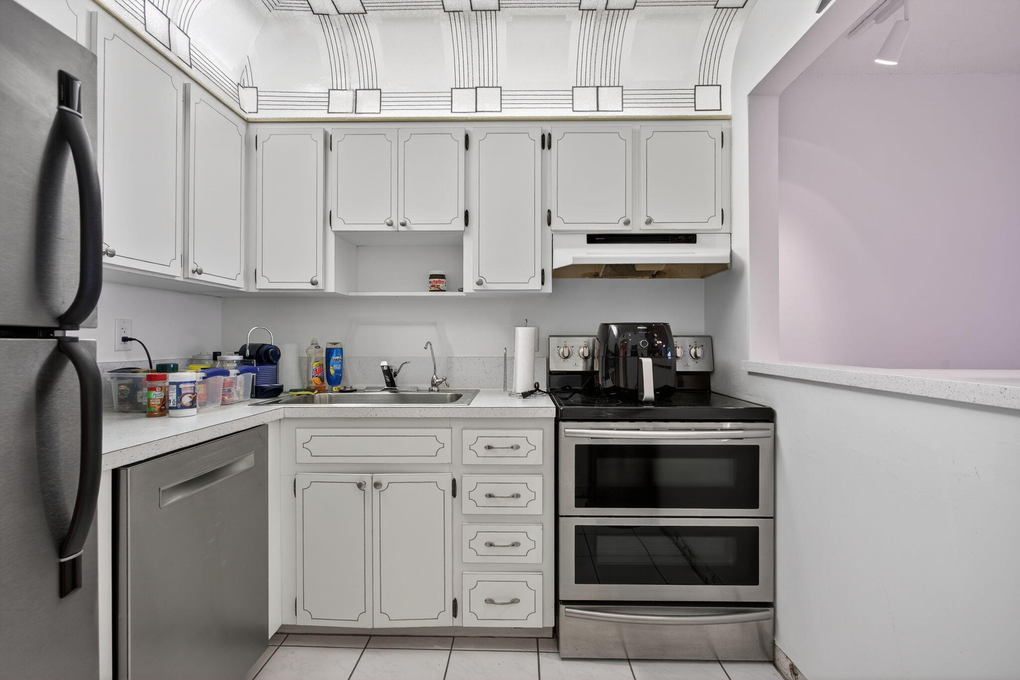 1505 North Riverside Drive, Unit 1107 Pompano Beach, FL 33062 - Photo 6 of 8 a kitchen with stainless steel appliances granite countertop a sink and cabinets