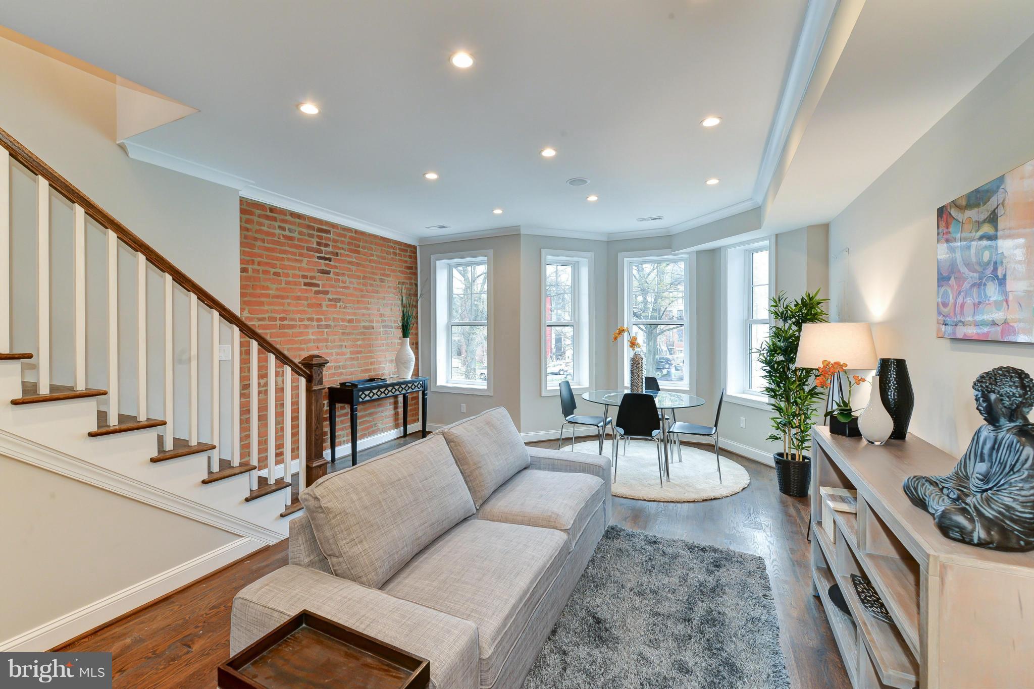 39 U Street Northeast, Unit 1 Washington, DC 20002 - Photo 2 of 27 a living room with furniture and wooden floor
