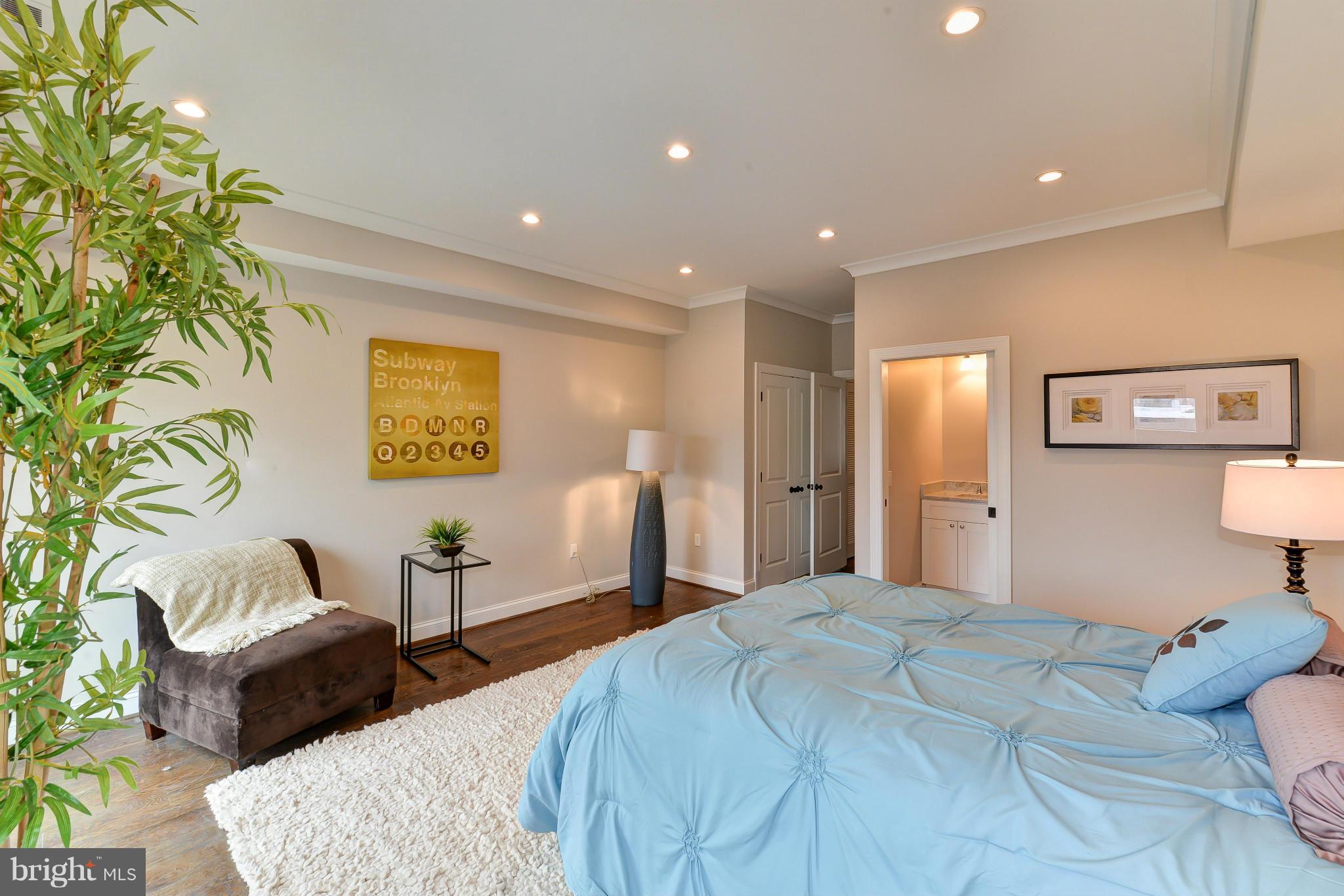 39 U Street Northeast, Unit 1 Washington, DC 20002 - Photo 12 of 27 a bedroom with a bed and a couch