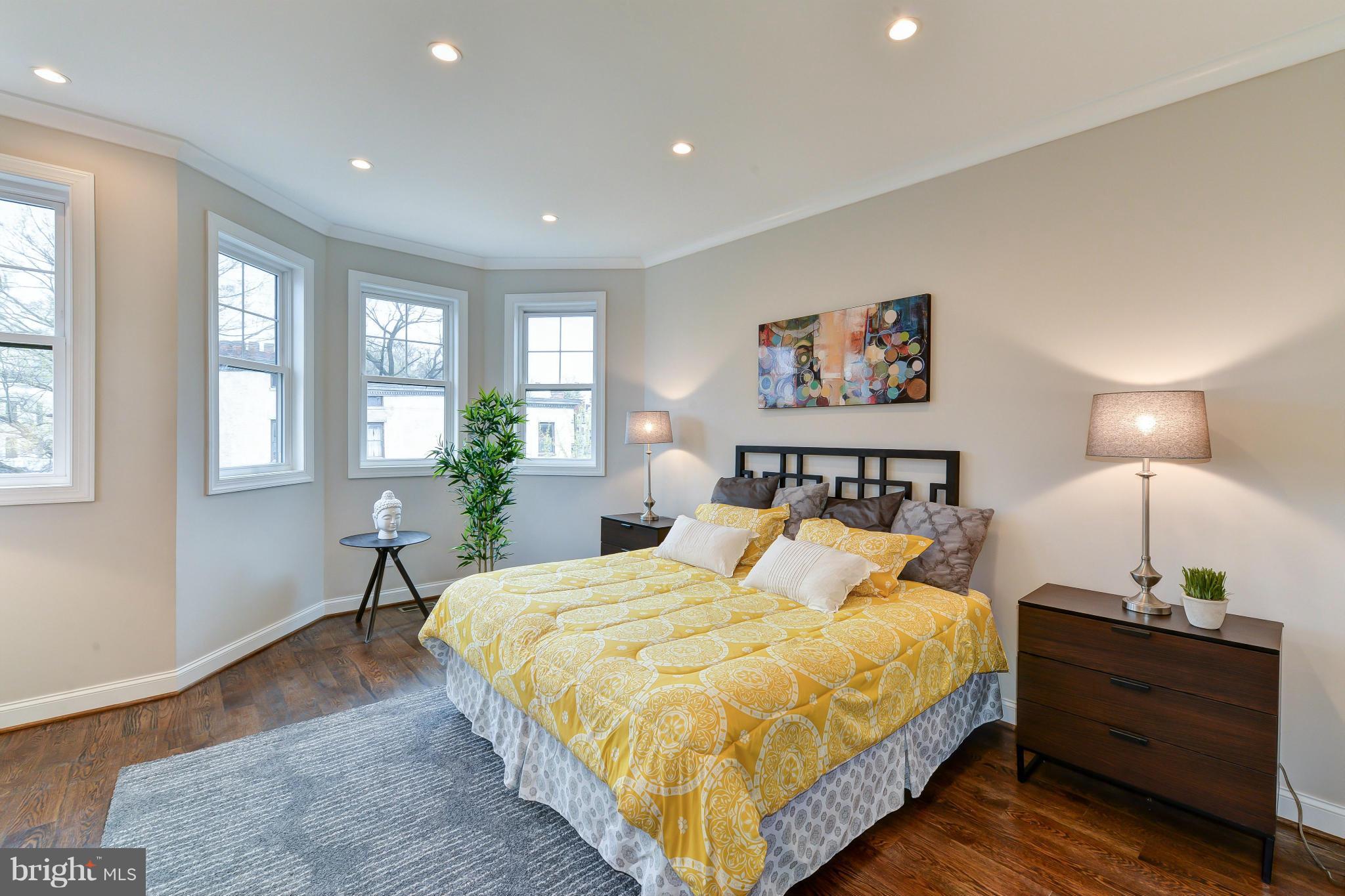 39 U Street Northeast, Unit 1 Washington, DC 20002 - Photo 14 of 27 a spacious bedroom with a bed and wooden floor