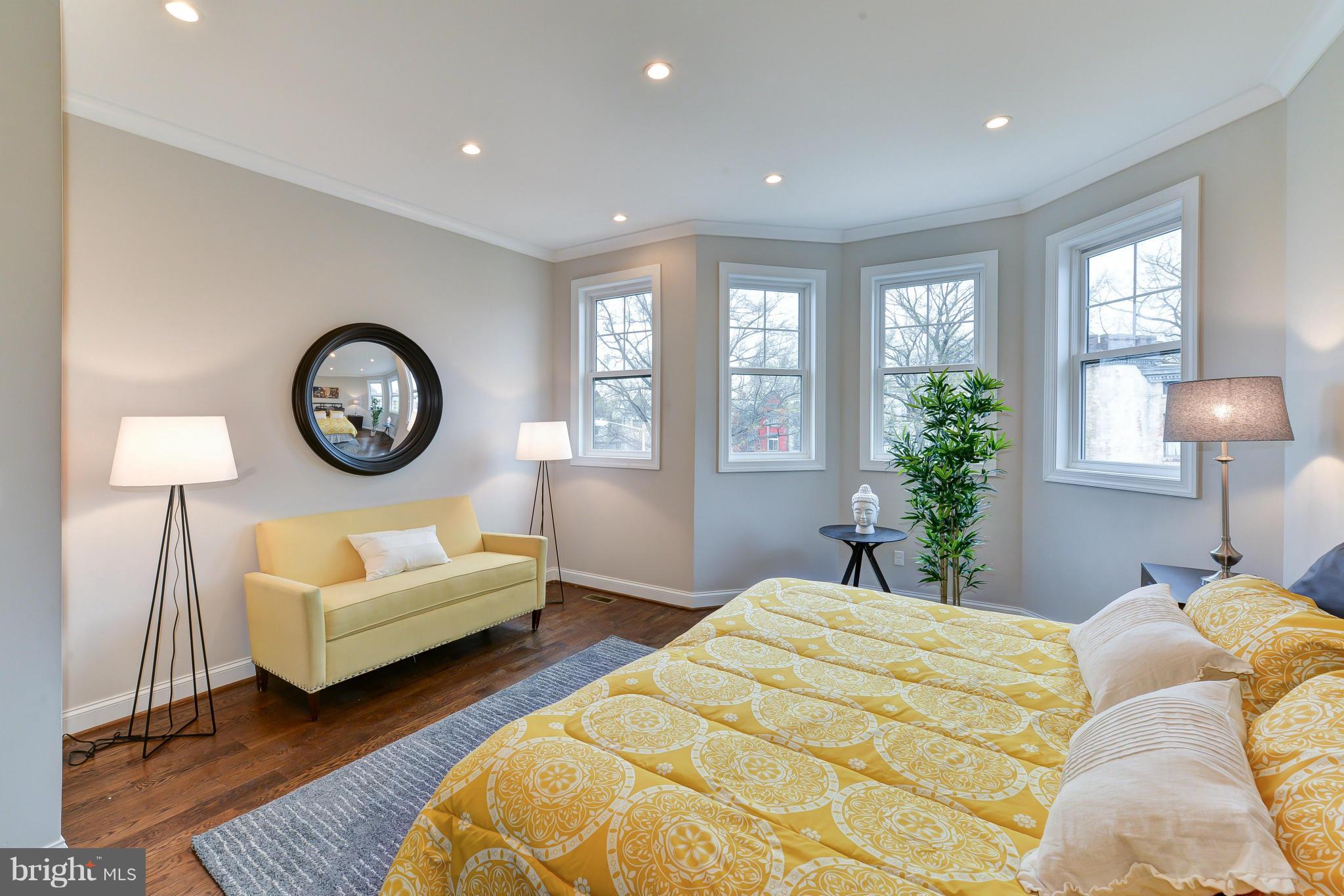 39 U Street Northeast, Unit 1 Washington, DC 20002 - Photo 15 of 27 a bedroom with a bed a mirror and a large window