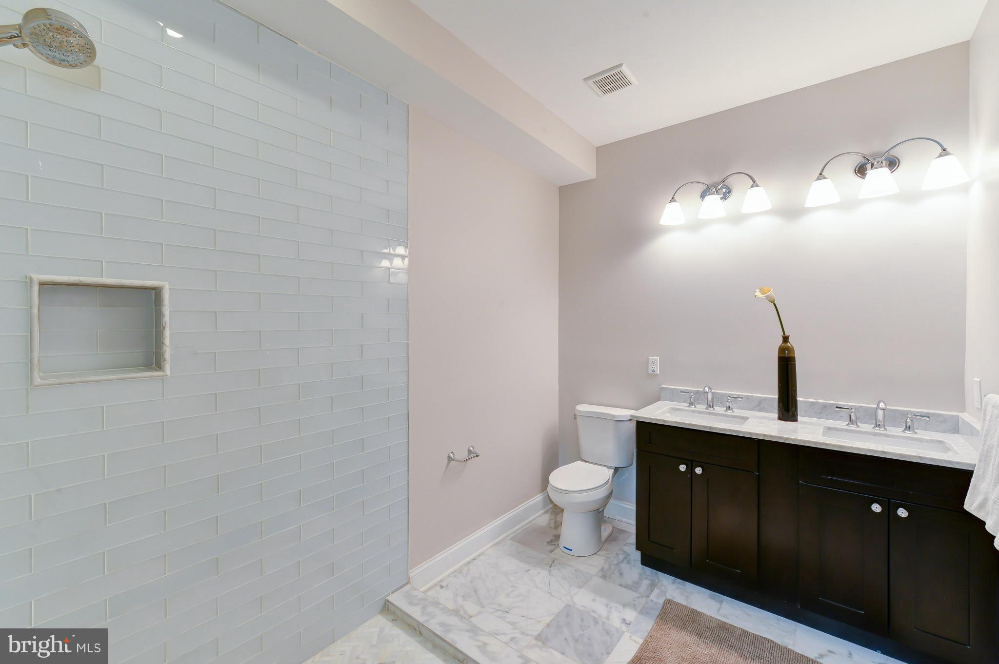 39 U Street Northeast, Unit 1 Washington, DC 20002 - Photo 18 of 27 a bathroom with a sink and a mirror