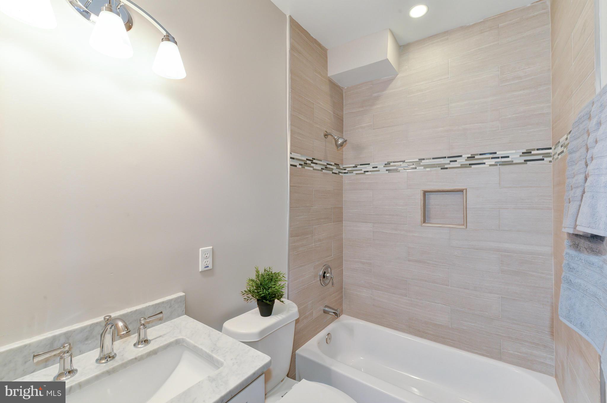 39 U Street Northeast, Unit 1 Washington, DC 20002 - Photo 21 of 27 a bath room with a sink and a bath tub