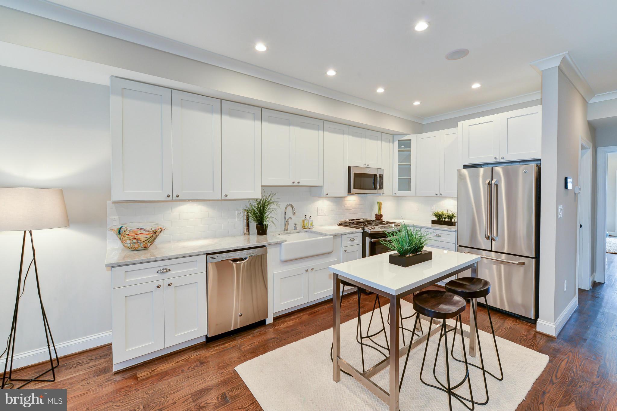 39 U Street Northeast, Unit 1 Washington, DC 20002 - Photo 6 of 27 a kitchen with white cabinets and stainless steel appliances