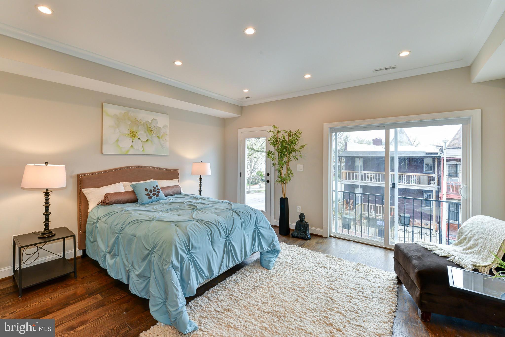 39 U Street Northeast, Unit 1 Washington, DC 20002 - Photo 10 of 27 a bedroom with a large bed and a large window