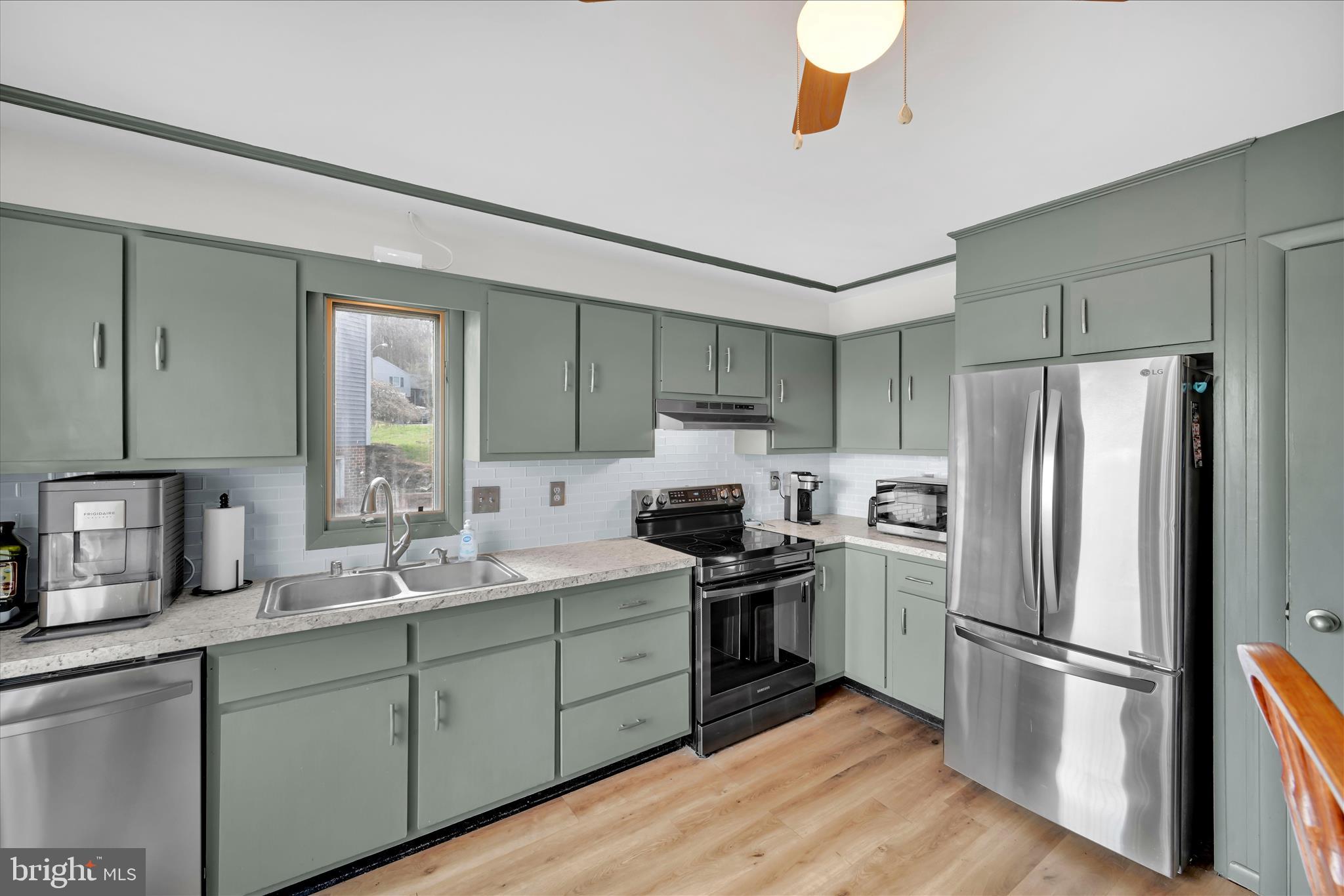 205 Pembroke Drive Reading, PA 19607 - Photo 11 of 40 a kitchen with a sink stainless steel appliances and cabinets
