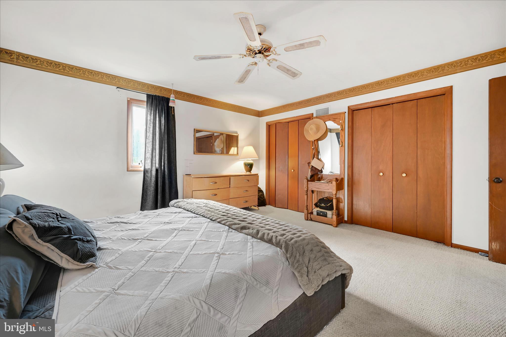 205 Pembroke Drive Reading, PA 19607 - Photo 25 of 40 a bedroom with a large bed and a chandelier