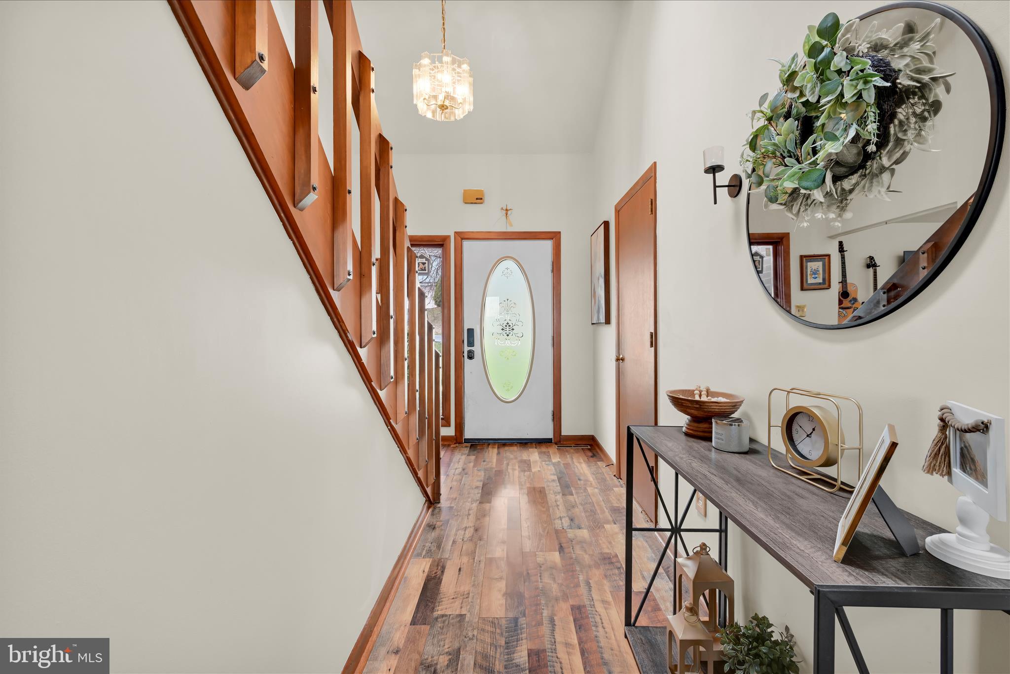 205 Pembroke Drive Reading, PA 19607 - Photo 6 of 40 a view of a hallway with wooden floor and a chandelier