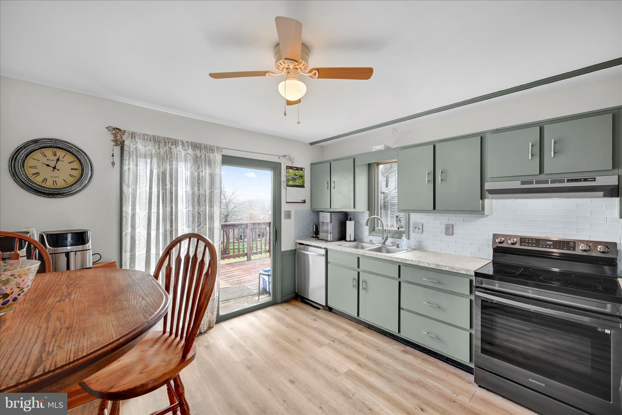 205 Pembroke Drive Reading, PA 19607 - Photo 10 of 40 a kitchen with a dining table chairs and a stove top oven