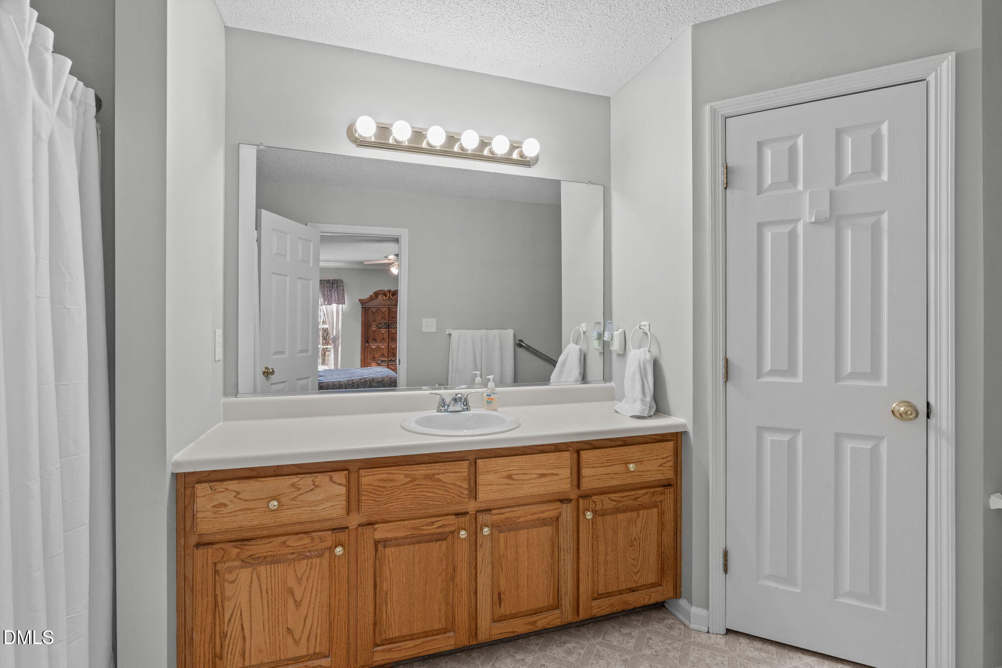 46 Budd Godwin Lane Dunn, NC 28334 - Photo 19 of 33 a bathroom with a sink and a mirror
