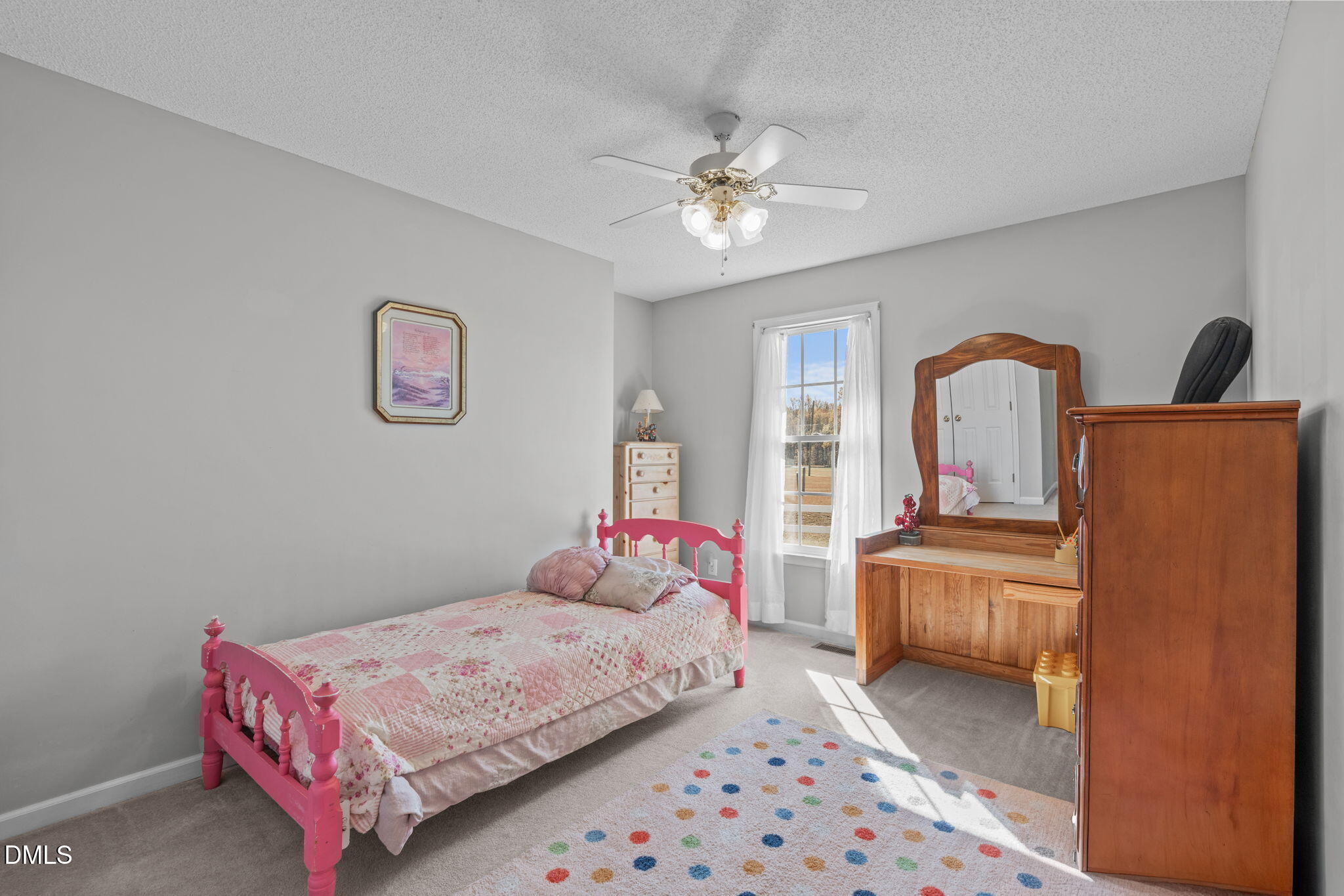 46 Budd Godwin Lane Dunn, NC 28334 - Photo 23 of 33 a bedroom with a bed and a chandelier