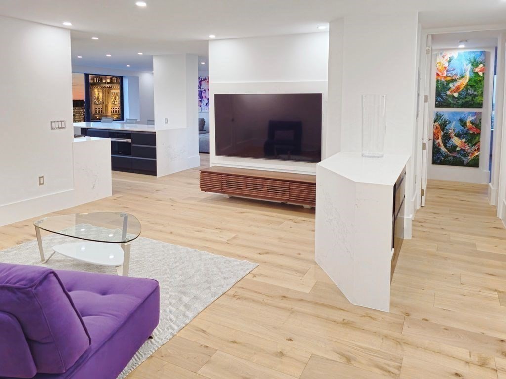 65 East India Row, Unit PH B Boston, MA 02110 - Photo 11 of 23 a living room with furniture and a flat screen tv