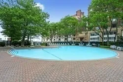 a view of a swimming pool with an outdoor space and seating area
