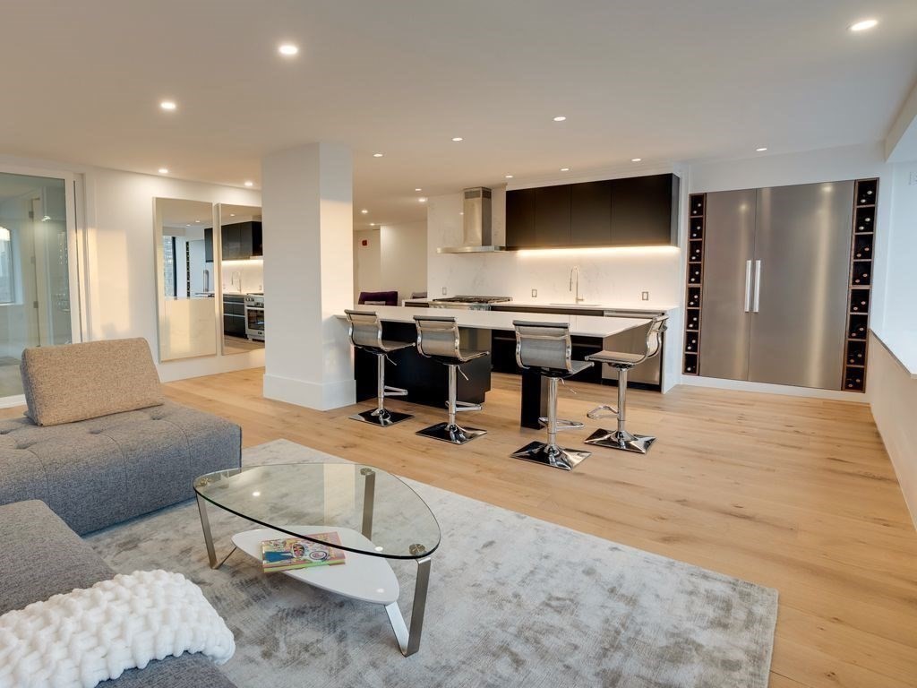65 East India Row, Unit PH B Boston, MA 02110 - Photo 6 of 23 a living room with furniture a dining table and kitchen view