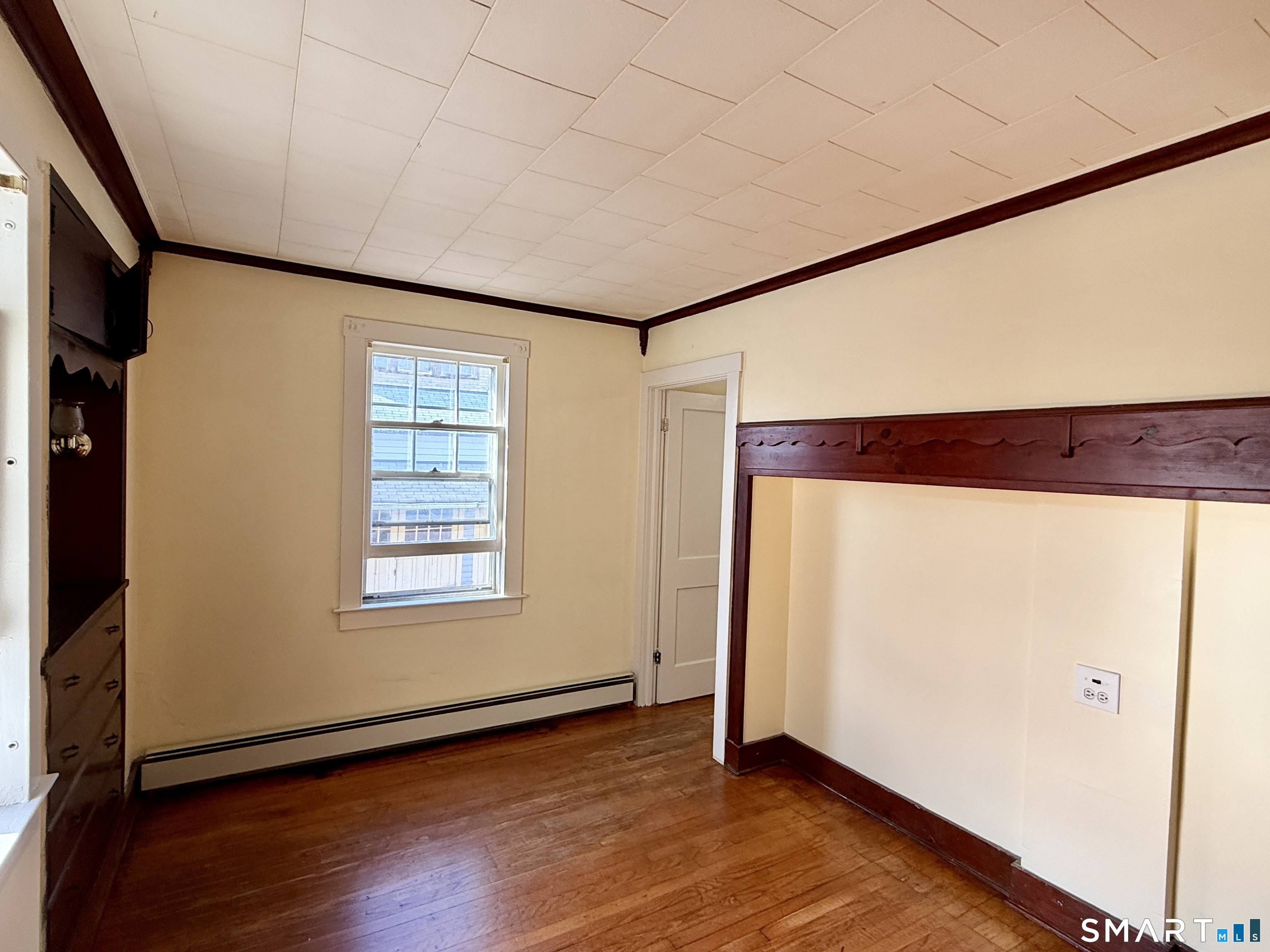 23 Farnham Avenue Torrington, CT 06790 - Photo 6 of 11 an empty room with wooden floor and windows