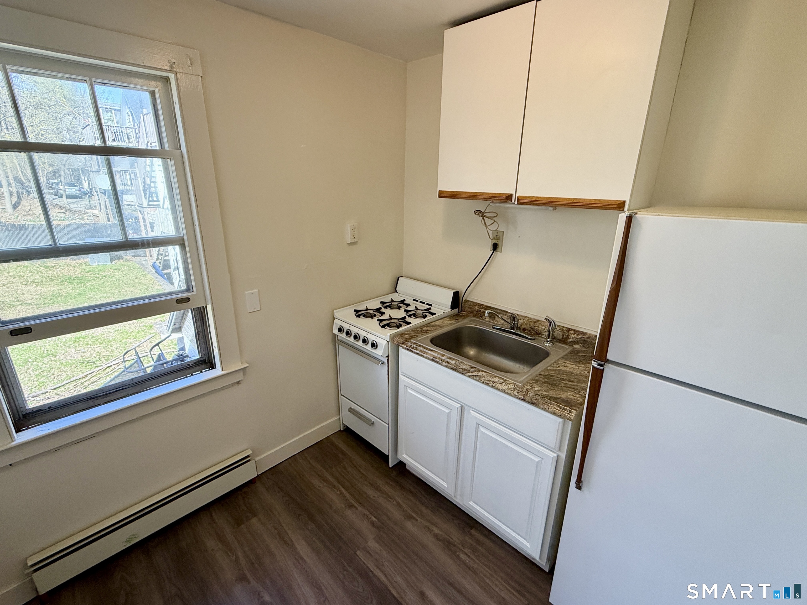 23 Farnham Avenue Torrington, CT 06790 - Photo 8 of 11 a kitchen with a sink a stove and cabinets