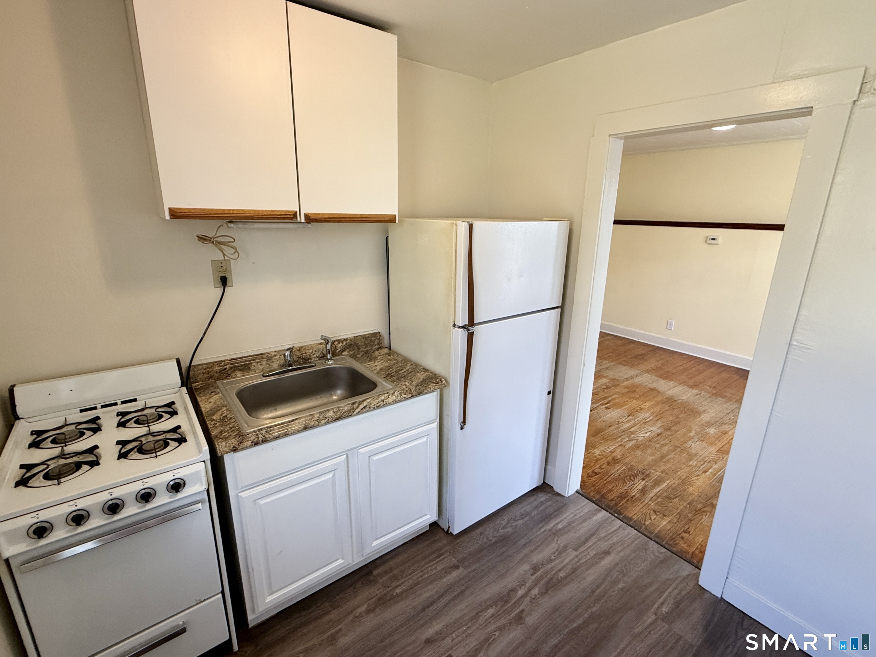 23 Farnham Avenue Torrington, CT 06790 - Photo 9 of 11 a kitchen with a refrigerator and a stove