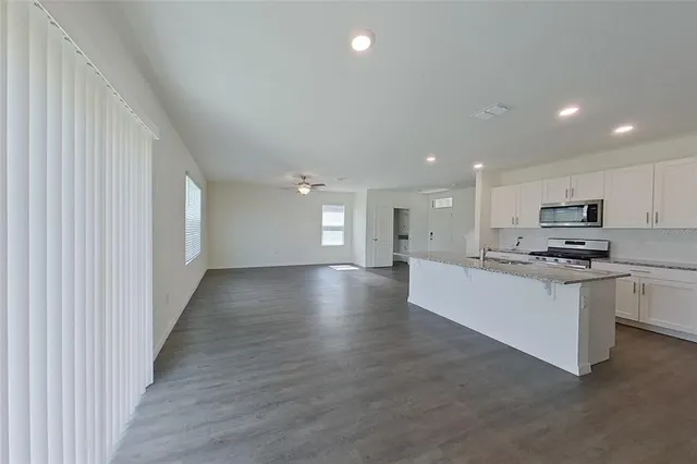 a view of kitchen with refrigerator sink and wooden floor
