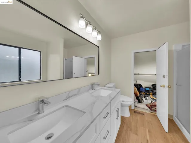 a spacious bathroom with a double vanity sink and a mirror