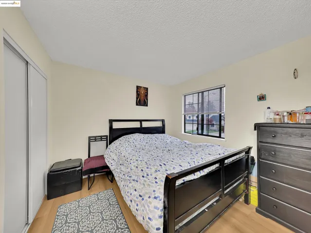 a bedroom with a bed and a dresser in it