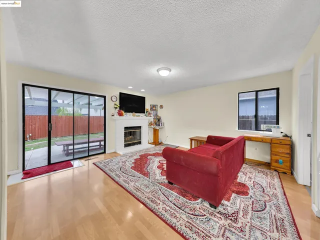 a living room with furniture fireplace and flat screen tv