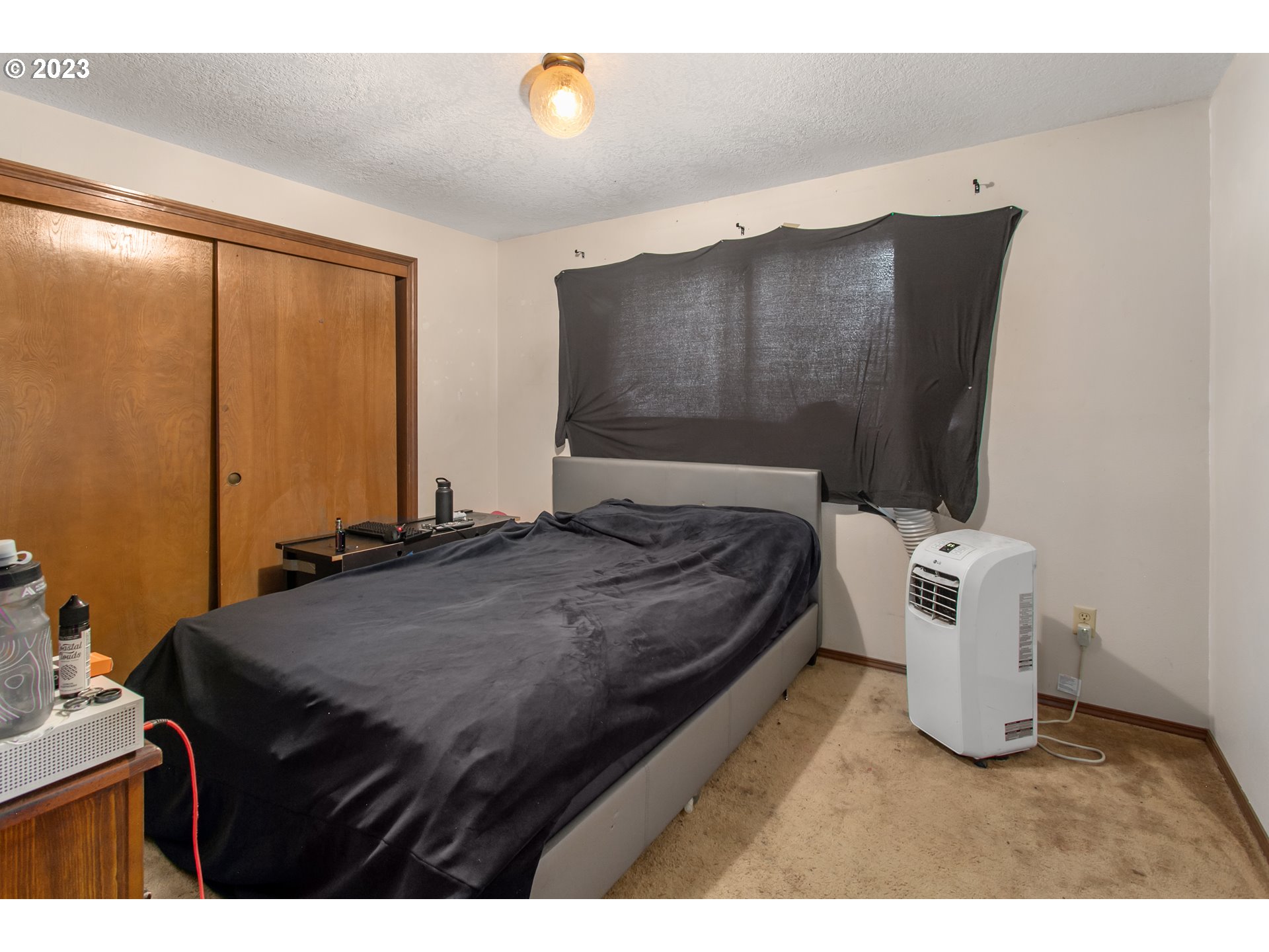 12705 Southeast Kelly Street Portland, OR 97236 - Photo 17 of 33 a bedroom with a bed and wooden floor