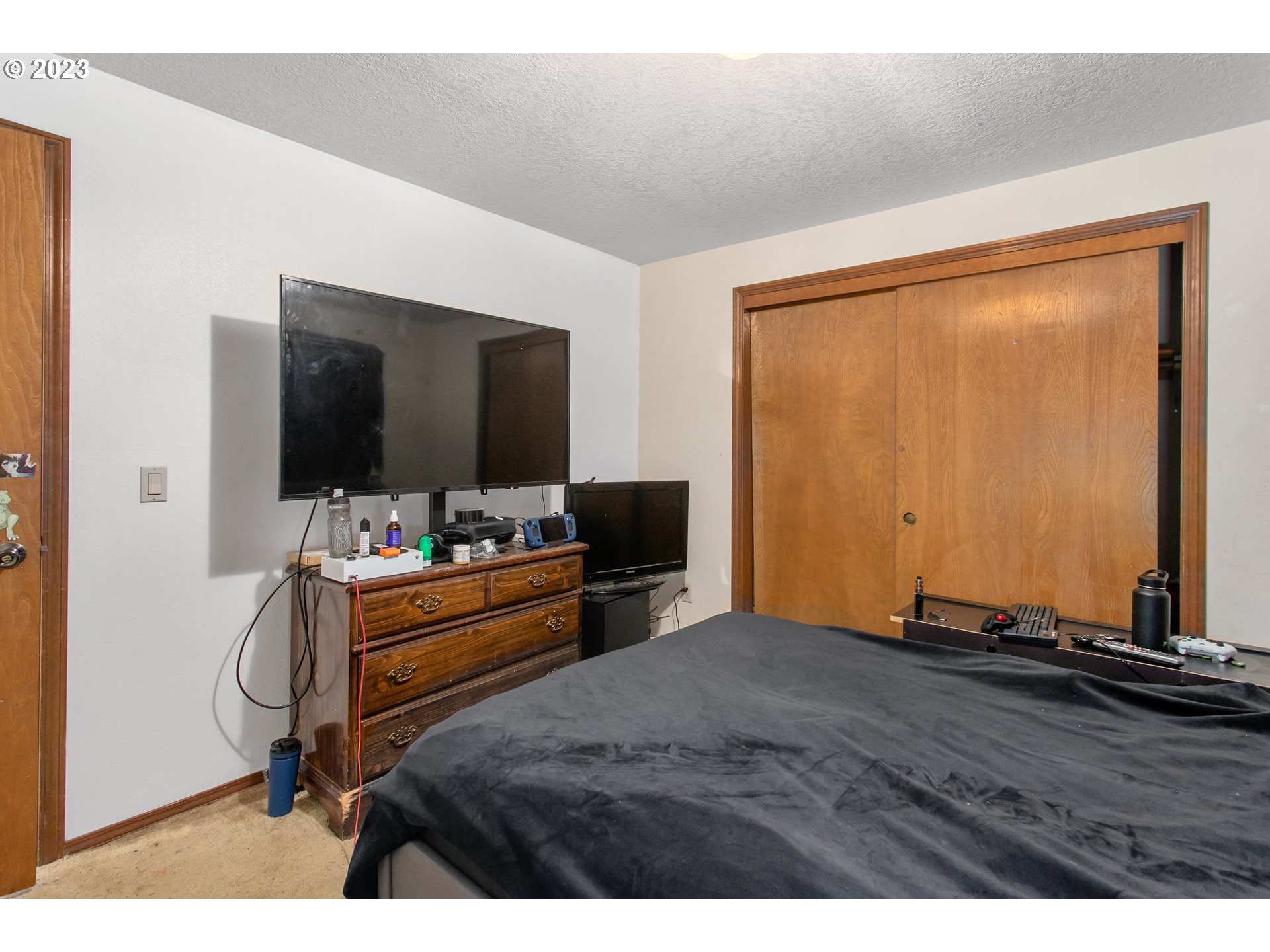 12705 Southeast Kelly Street Portland, OR 97236 - Photo 18 of 33 a bedroom with a bed and a flat screen tv