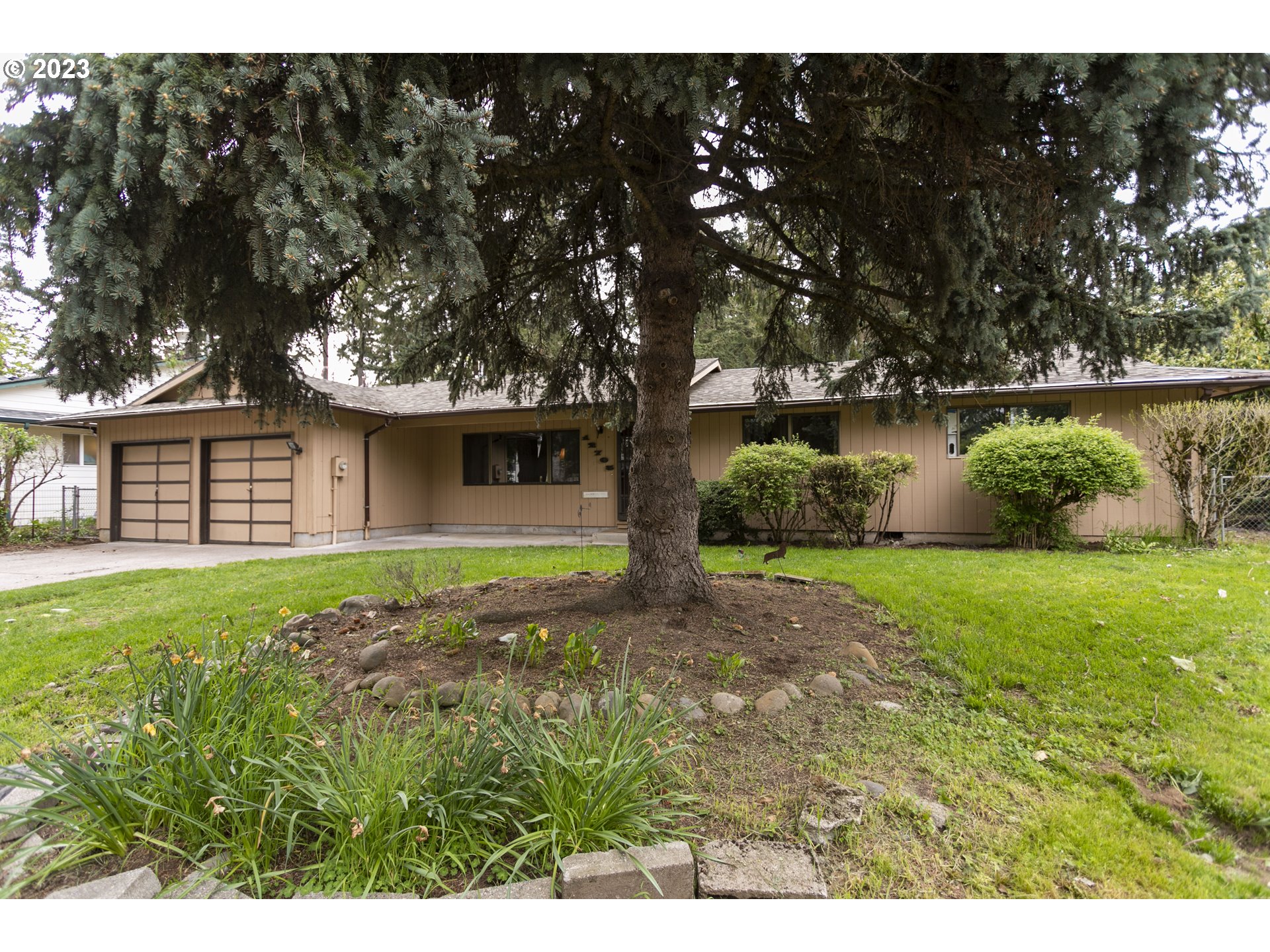 12705 Southeast Kelly Street Portland, OR 97236 - Photo 2 of 33 a view of a backyard with large trees