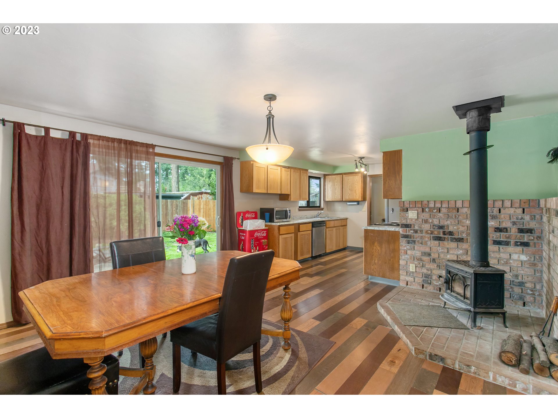 12705 Southeast Kelly Street Portland, OR 97236 - Photo 25 of 33 a view of a dining room with furniture and a chandelier