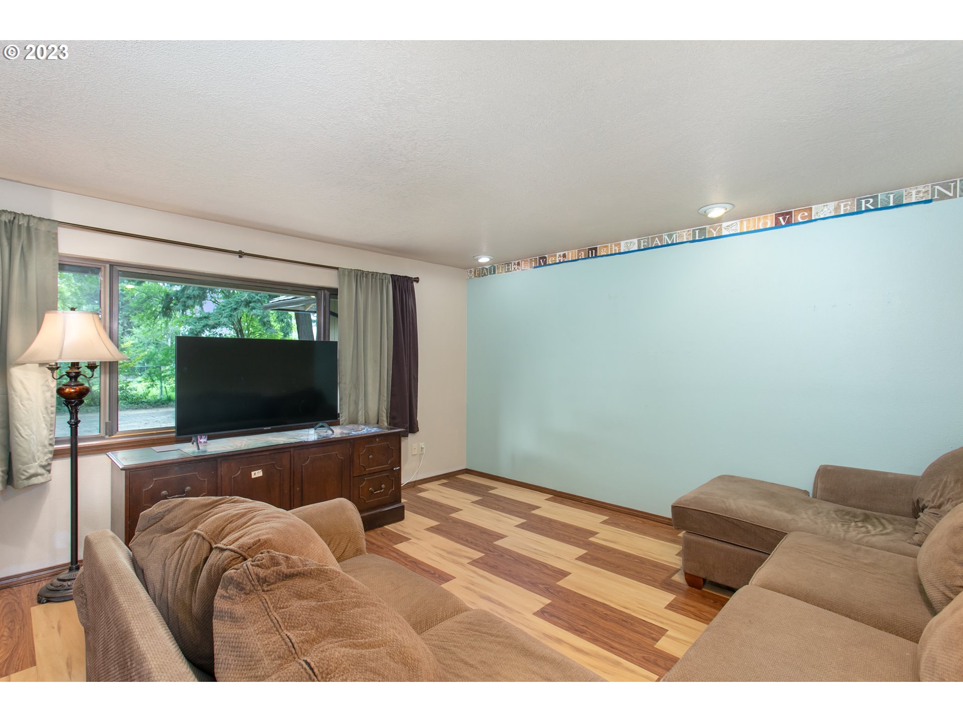 12705 Southeast Kelly Street Portland, OR 97236 - Photo 4 of 33 a living room with furniture and a flat screen tv