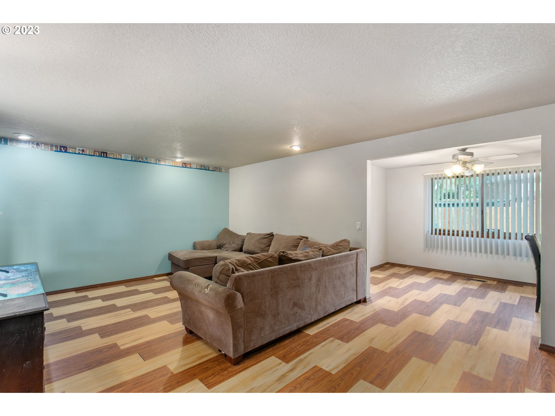 12705 Southeast Kelly Street Portland, OR 97236 - Photo 5 of 33 a living room with furniture and a floor to ceiling window