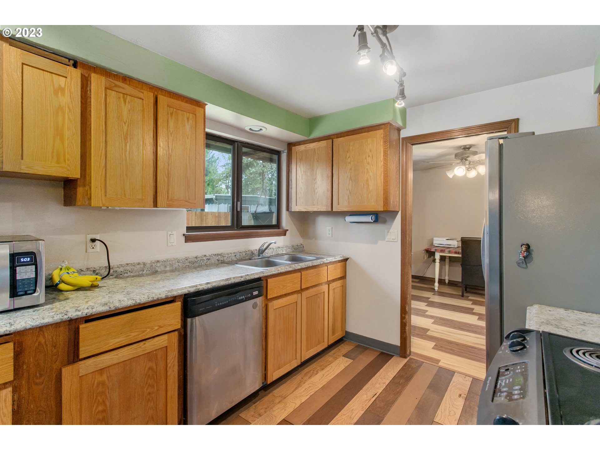 12705 Southeast Kelly Street Portland, OR 97236 - Photo 9 of 33 a kitchen with stainless steel appliances granite countertop a sink stove and cabinets