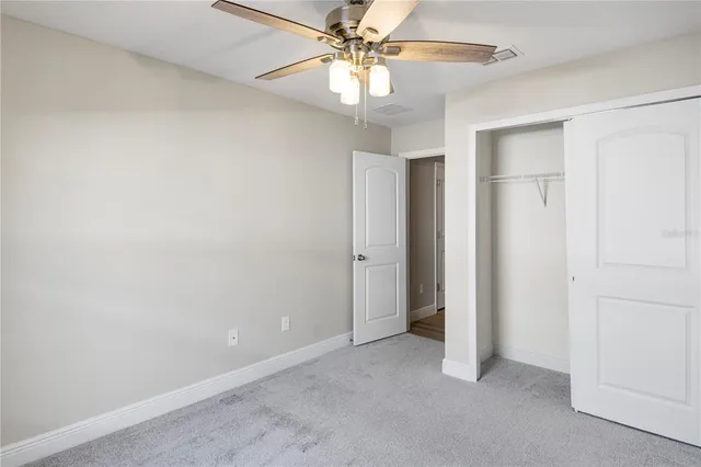 an empty room with closet and entryway