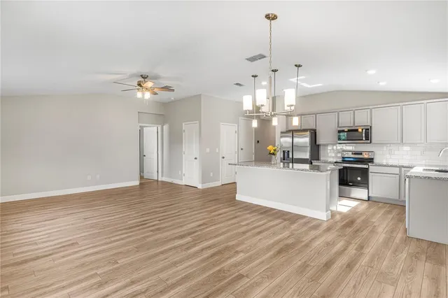 a view of kitchen with granite countertop cabinets counter top space and stainless steel appliances