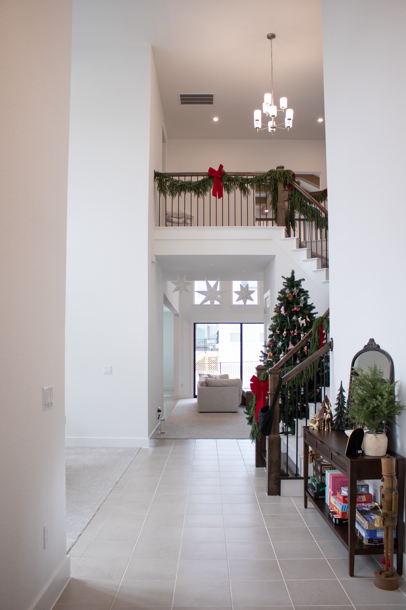 1709 Novara Trail Leander, TX 78641 - Photo 14 of 40 Hall with a high ceiling, suspended lighting, and light tile patterned floors
