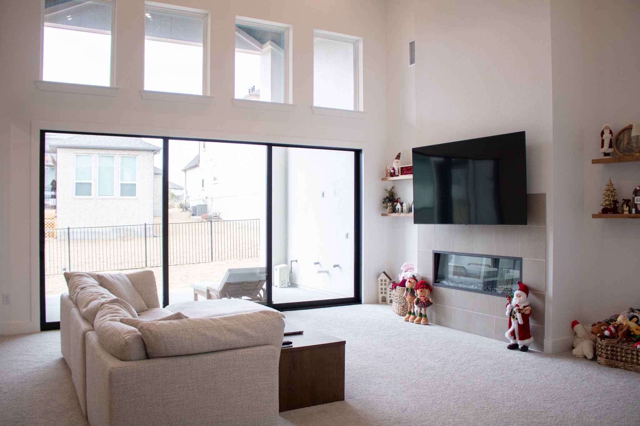 1709 Novara Trail Leander, TX 78641 - Photo 15 of 40 Living room with carpet, a fireplace, and a high ceiling
