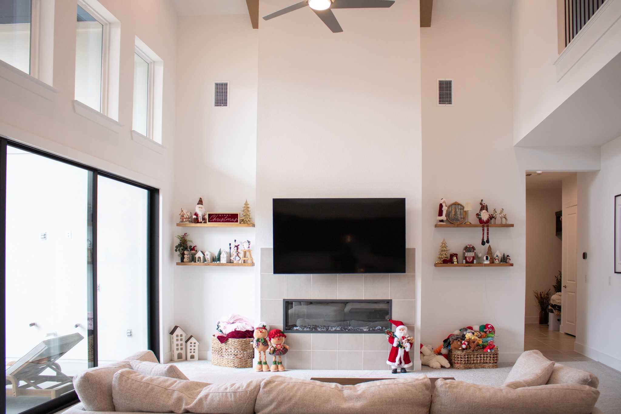 1709 Novara Trail Leander, TX 78641 - Photo 16 of 40 Living room featuring a tile fireplace, a high ceiling, and a ceiling fan