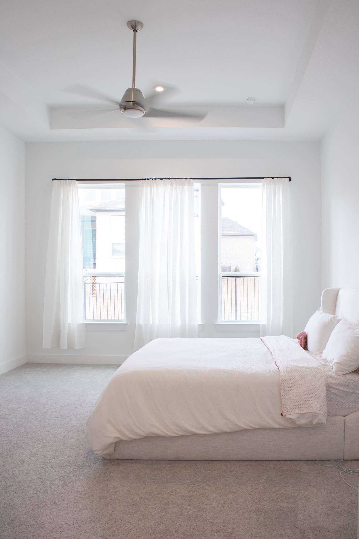 1709 Novara Trail Leander, TX 78641 - Photo 24 of 40 Carpeted bedroom with a tray ceiling and ceiling fan