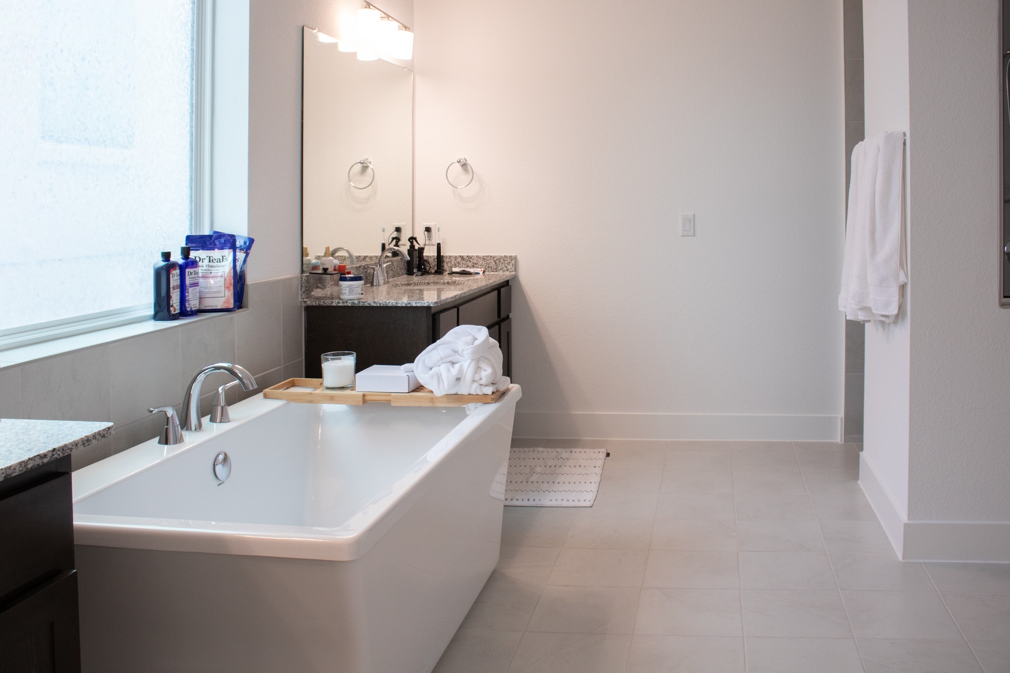 1709 Novara Trail Leander, TX 78641 - Photo 28 of 40 Bathroom featuring vanity, a soaking tub, and light tile patterned flooring